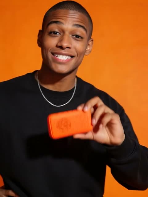 Man holding an orange phone